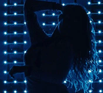 Model dancing in front of LED lights